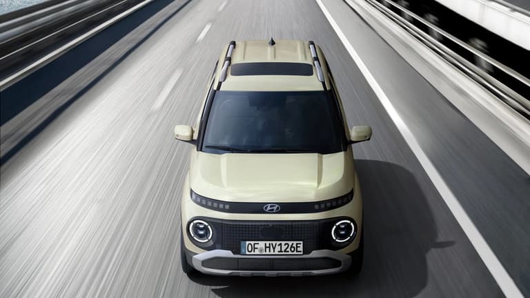 Горен преден изглед на движещ се нов Hyundai INSTER малък електрически автомобил.