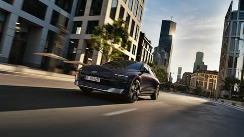 Hyundai IONIQ 6 driving on a city street.
