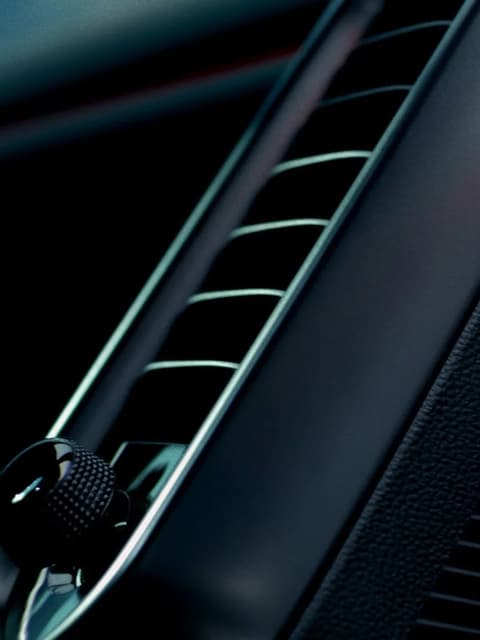 Hyundai IONIQ 3 interior air vents close-up in black and metallic silver.