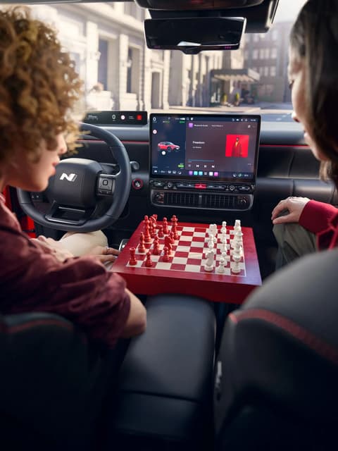 Hyundai IONIQ 3 interior centre console with a wooden chessboard between the front seats.