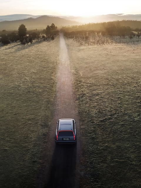 Hyundai IONIQ 9 електрически SUV, движещ се по черен път, гледан отгоре.
