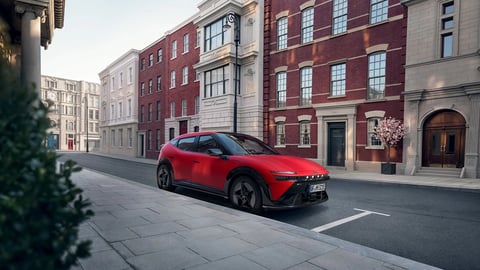 Червен Hyundai IONIQ 3 N Line, паркиран на градска улица пред красиви стари сгради.