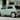 The Hyundai INSTER Lounge in Glow Mint parked on the city street.