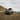 The front view of Hyundai INSTER Cross parked on the hill.
