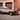 Ретро снимка на Hyundai TUCSON от 2005 г., паркиран до сграда, с жена, облегната на капака.