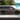 Hyundai Santa Fe Hybrid, паркиран пред модерна къща с икона на смартфон.