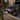Woman walking past IONIQ 6 whilst plugged into home charger.