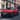 Red Hyundai IONIQ 3 driving in the urban street.