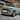 A close-up image of Hyundai INSTER Lounge in Glow Mint driving on the street.